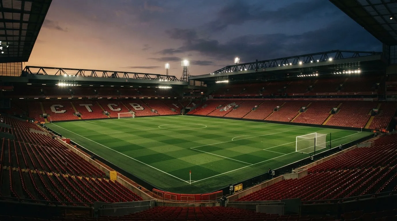 An empty football stadium with floodlight masts at dusk