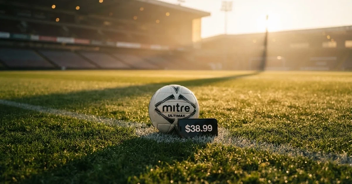 A ball on the centre spot of a grass pitch in morning light